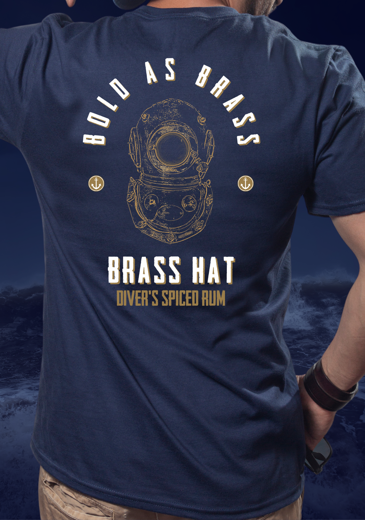 Back view of man wearing T-shirt in navy blue with bold as brass written on it deep sea diver diving helmet logo anchor motifs and Brass Hat Diver's Spiced Rum name