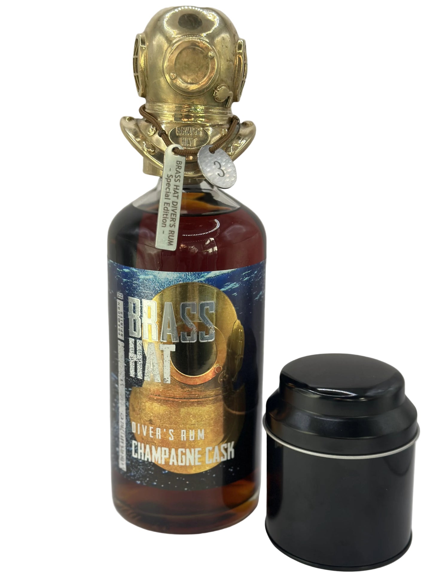 Bottle of 'Brass Hat' Diver's Champagne Cask rum with a special edition brass diving helmet on top, along side its black collectors tin, showcasing the perfect diver's gift for collectors