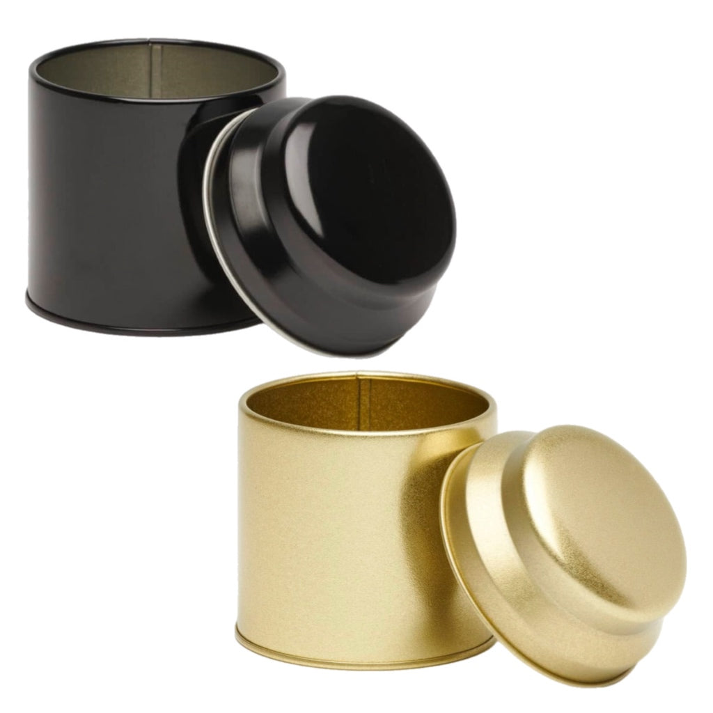 Black and gold cylindrical containers with lids on a white background