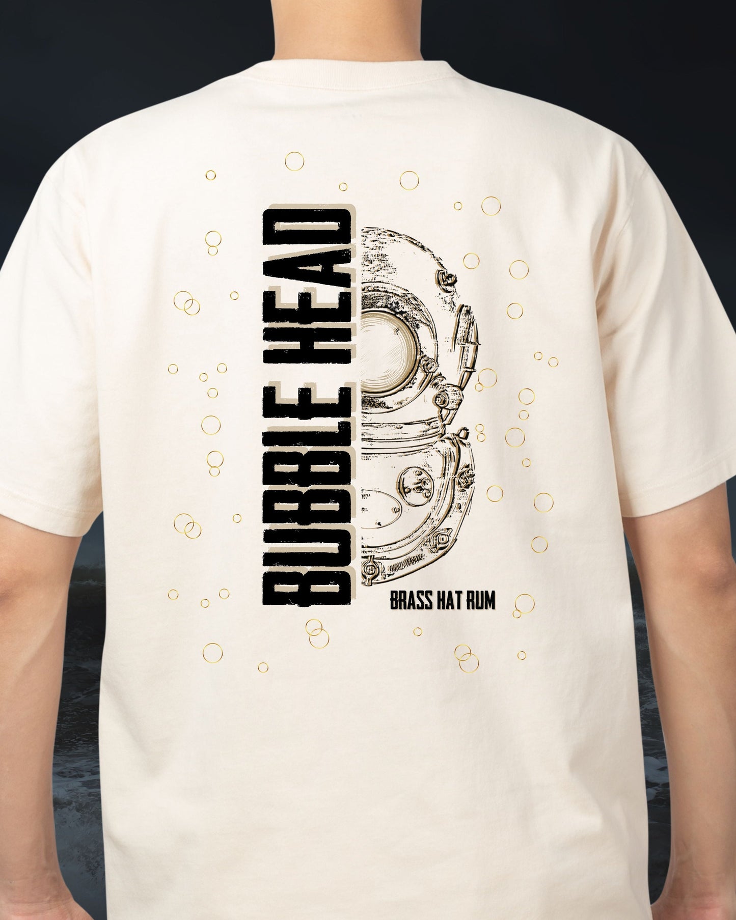 Person wearing Brass Hat Rum sand coloured ‘Bubble Head’ t-shirt.  Half Siebe Gorman diver helmet design & Bubble Head branding on the back – divers’ gifts and ocean-inspired apparel