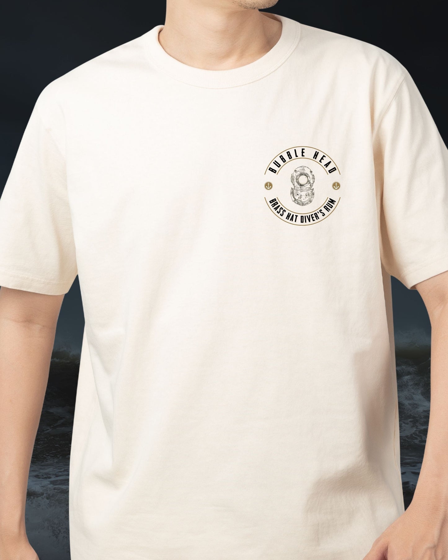 Front view of person wearing Brass Hat Diver’s Rum sand coloured ‘Bubble Head’ t-shirt with Siebe Gorman diver helmet logo – divers’ gifts and ocean-inspired apparel
