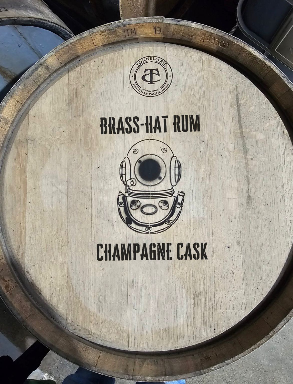 Close-up of actual Brass Hat Rum Champagne Cask with embossed diver’s logo, symbolising craftsmanship and unique rum gifting inspiration