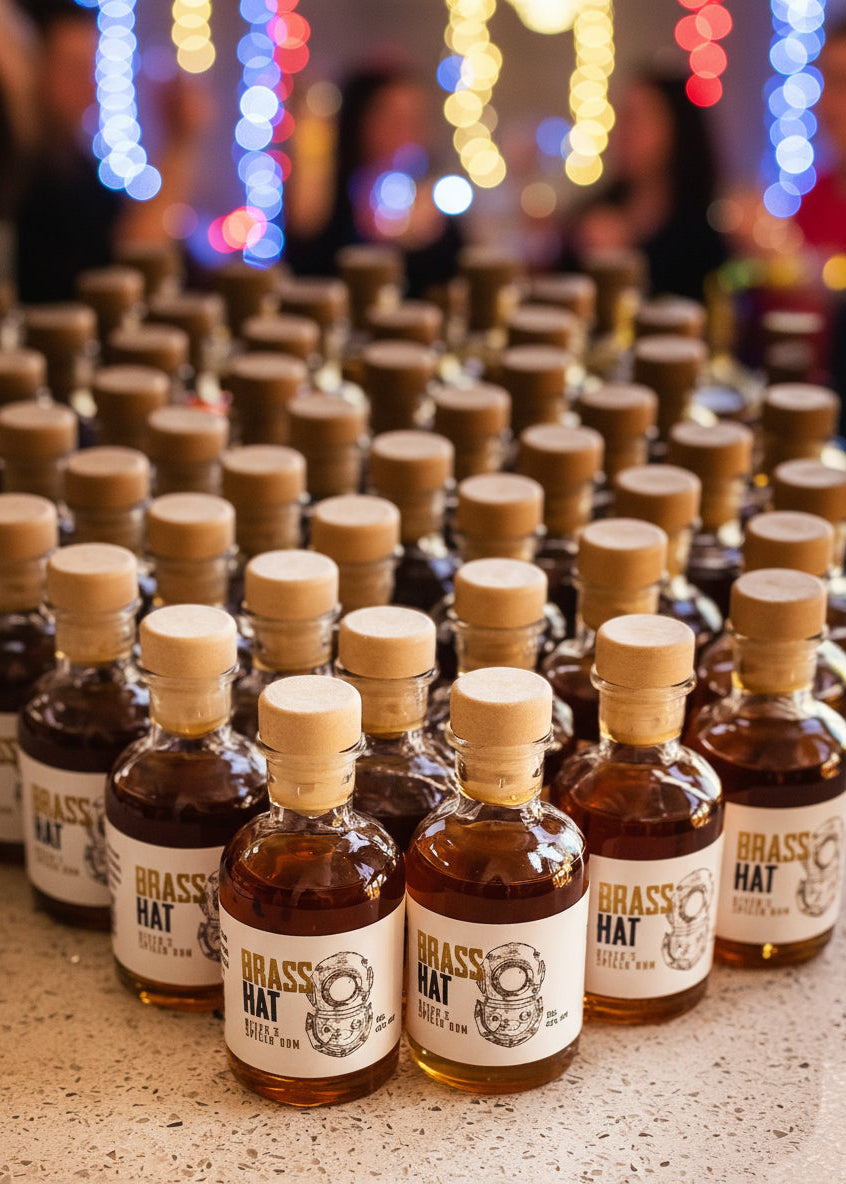 Miniature bottles of Brass Hat Diver’s Rum arranged at a party, ideal for wedding favours, event gifts, or festive celebrations
