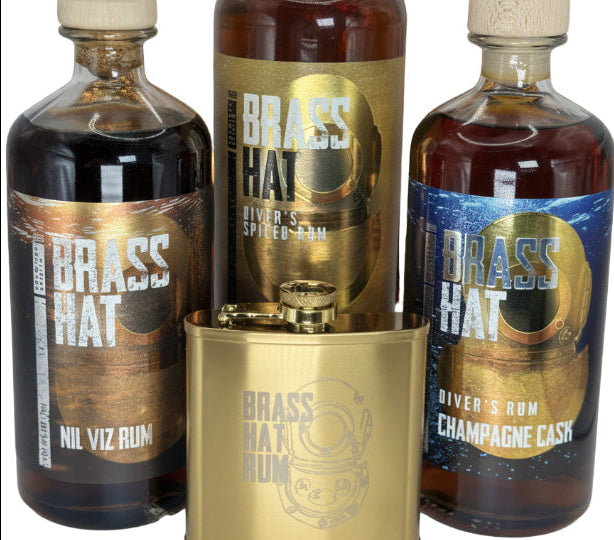 Brass Hat Rum gift set with three full size premium bottles and a branded hip flask — ideal Christmas gift for divers and rum enthusiasts. White Background