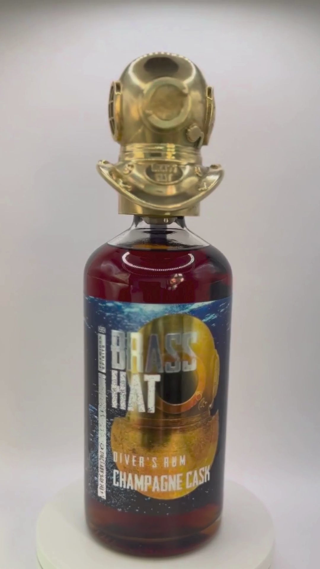 Showcase video of Brass Hat Diver's Helmet Bottle Topper rotating on a bottle of Brass Hat Diver's Champagne Cask Rum. Perfect Diver's Gift
